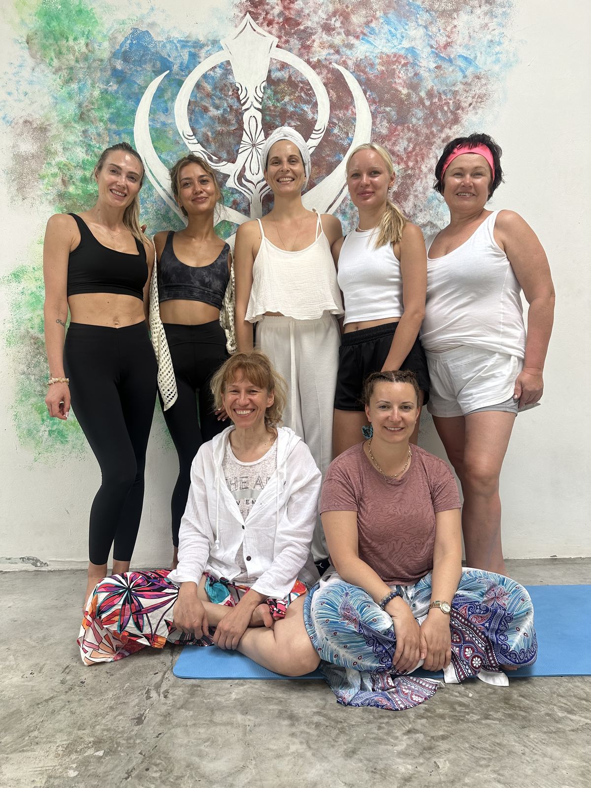 Students in front of the studio mural